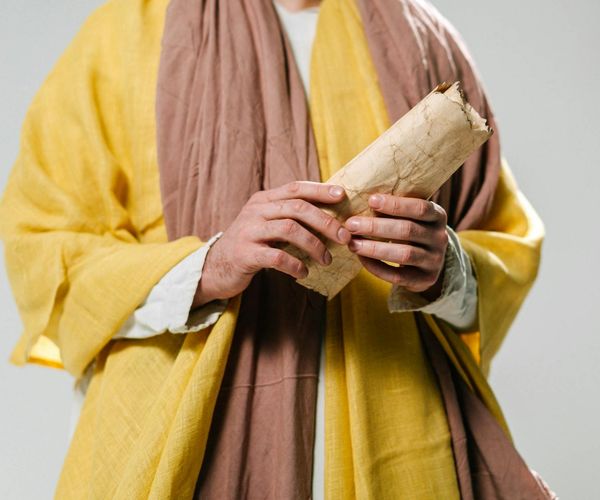 Ancient yoga manuscript with soft, focused light on the text.